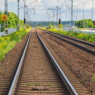 Industrial view of railroad track in city on summer day. Transportation concept background. Sweden.